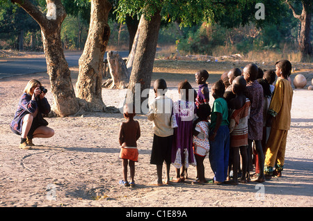 Senegal, Casamance, a young European is taking the picture of a group of children Stock Photo