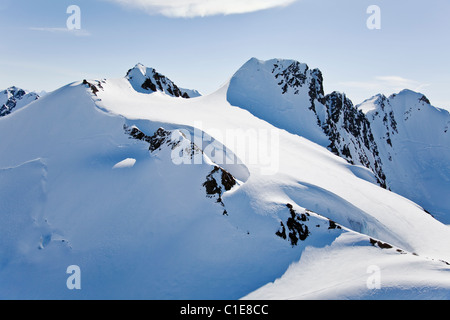 Deep snow layers cover the Chugach Mountains in Chugach State Park near Anchorage, Alaska in spring. Stock Photo