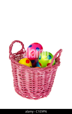 Several colorful painted easter eggs in pink basket Stock Photo