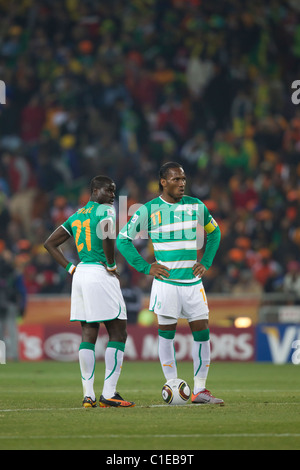 Cote d'Ivoire players Emmanuel Eboue (21) and Didier Drogba (11) wait to kick off the ball after conceding a goal to Brazil. Stock Photo