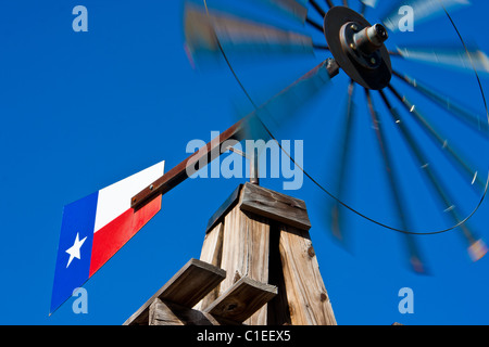 A windmill with a Texas flag, normally found on a farm, mounted in front of the historic Rogers Hotel, Waxahachie, Texas. Stock Photo