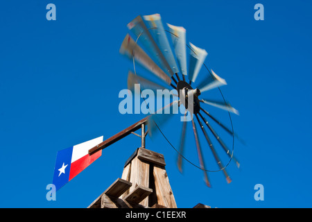 A windmill with a Texas flag, normally found on a farm, mounted in front of the historic Rogers Hotel, Waxahachie, Texas. Stock Photo