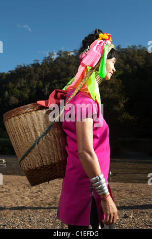 Long Neck Karen woman back to the refugee village from small Veg. farm, Huay Pu Keng, Mae Hong Son, Thailand Stock Photo