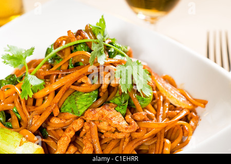 classic fresh chinese fried noodles with pork and vegetables and coriander on top Stock Photo