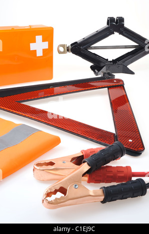 Emergency kit for car - first aid kit, car jack, jumper cables, warning triangle, reflective vest Stock Photo