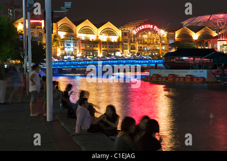 People relaxing at the riverside district of Clarke Quay, Singapore Stock Photo