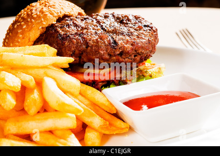 fresh classic american hamburger sandwich with french fries and ketchup sauce on side Stock Photo