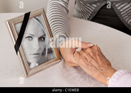 Holding hands for comfort. Grief at death. Stock Photo