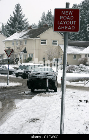 A car propped up on a road bollard following an accident on the icy roads in Salisbury in the winter of 2010 Stock Photo