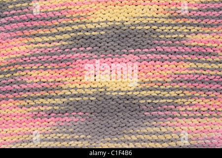 Background, knitted fabrics, rose, gray, yellow thread Stock Photo