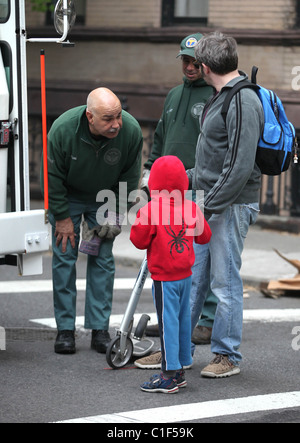 Matthew Broderick plays the doting father as he takes son James Broderick to school on a scooter, stopping to chat to an Stock Photo