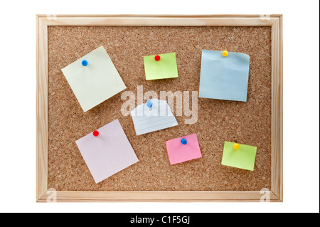 different sticky notes on a cork board isolated on a white background Stock Photo