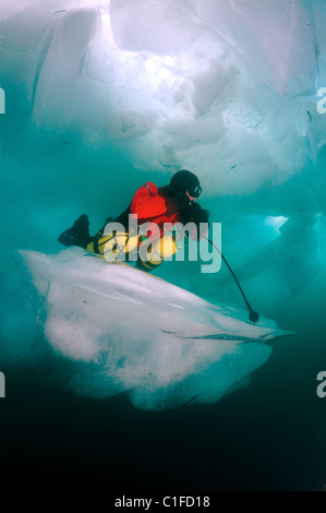 Scuba diver with sidemount under ice, in lake Baikal, Siberia, Russia, island Olkhon Stock Photo