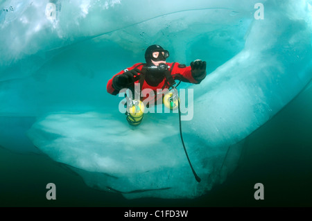 Scuba diver with sidemount under ice, in lake Baikal, Siberia, Russia, island Olkhon Stock Photo