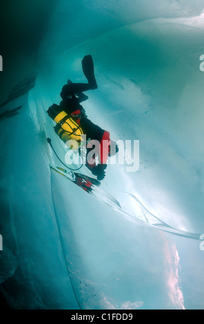 Scuba diver with sidemount under ice, in lake Baikal, Siberia, Russia, island Olkhon Stock Photo