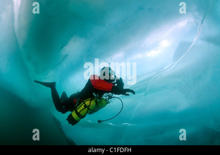 Scuba diver with sidemount under ice, in lake Baikal, Siberia, Russia, island Olkhon Stock Photo