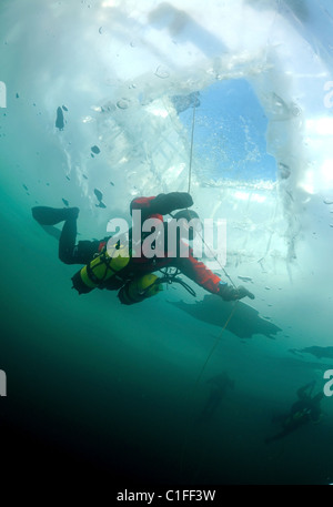 Scuba diver with sidemount under ice, in lake Baikal, Siberia, Russia, island Olkhon Stock Photo