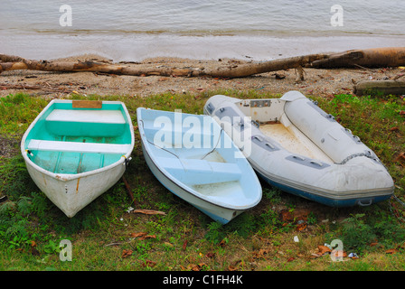 three dingy boats on shore Stock Photo