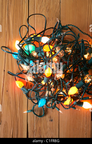 Glowing Christmas lights tangled on floor Stock Photo