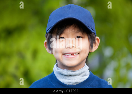 Smiling Korean boy in baseball cap Stock Photo