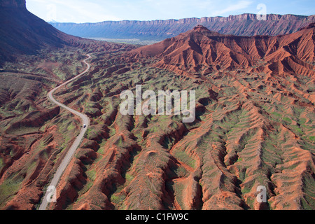 AERIAL VIEW. Winding road in a barren landscape. La Sal Mountain Loop Road; access road to Castle Valley. Moab area, Grand County, southern Utah, USA. Stock Photo