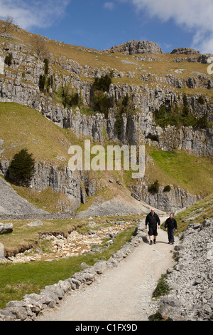 Hikers on track to Gordale Scar, Malham, North Yorkshire, England, United Kingdom Stock Photo