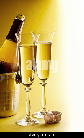 Champagne bottle in cooler and two champagne glasses. Stock Photo