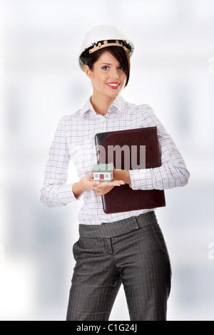 Young businesswoman holding house model Stock Photo