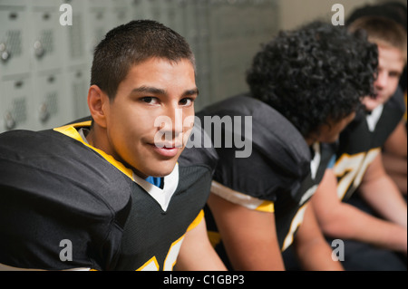 Football players dressing in locker room Stock Photo