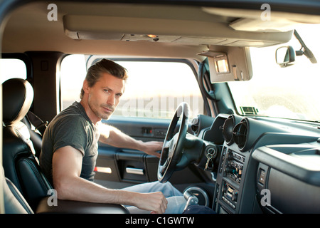 Caucasian man getting into truck Stock Photo