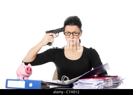 Female killing her self while filling out tax forms while sitting at her desk. Isolated Stock Photo