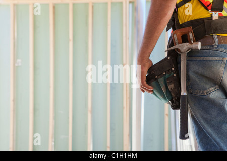 Mid section view of a carpenter wearing a tool belt Stock Photo