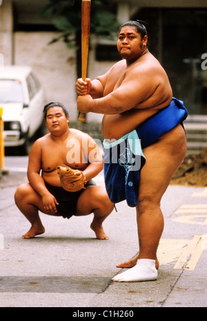 Japan, sumo wrestlers playing baseball Stock Photo