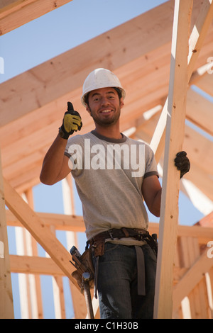 Carpenter showing thumbs up sign and smiling Stock Photo