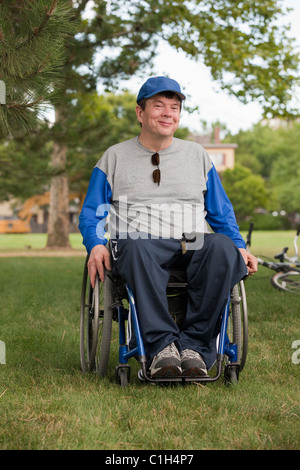 Boy with cerebral palsy riding a bicycle Stock Photo