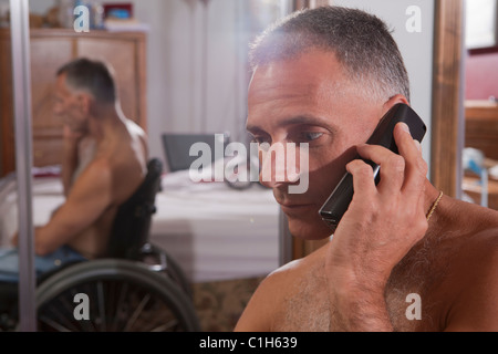 Man with spinal cord injury talking on a mobile phone Stock Photo