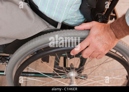 Man with spinal cord injury sitting in a wheelchair Stock Photo