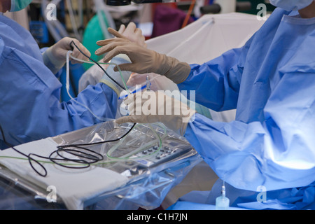 Ophthalmologist performing cataract surgery with surgical technologist Stock Photo