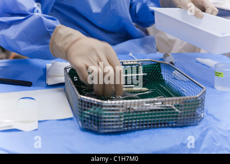 Surgical technologist cleaning the back table Stock Photo