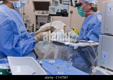 Surgical technologist passing antibiotic to doctor Stock Photo