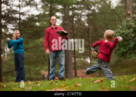 Boy playing baseball with his parents and using sign language to communicate Stock Photo