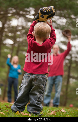 Boy playing baseball with his parents and using sign language to communicate Stock Photo