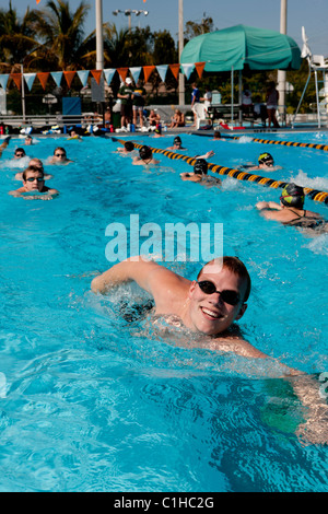 Male competitor in the collegiate Orange Bowl Swimming Classic doing a front or forward crawl for warm-up purposes. Stock Photo