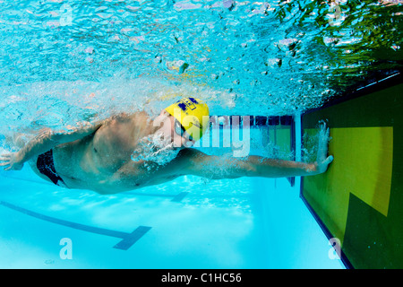 Male competitor in the collegiate Orange Bowl Swimming Classic finishes race. Stock Photo