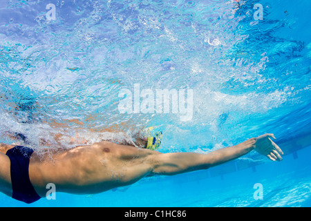 Male swimmer competes in a backstroke event at the annual Orange Bowl Swimming Classic, Key Largo, Florida Stock Photo