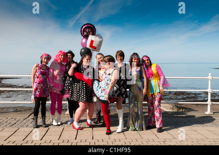 A group of women dressed in fancy dress 1970s clothes on a batchelorette hen party in Aberystwyth Wales UK Stock Photo