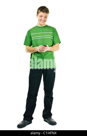 Happy young man texting on cellphone standing full body isolated on white background Stock Photo