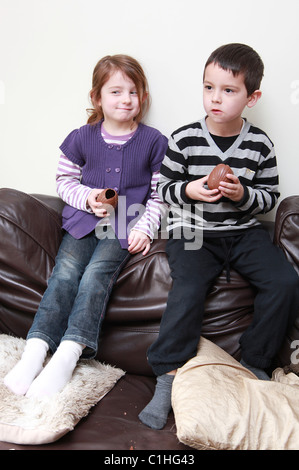 Children eating chocolate Easter Eggs, UK Stock Photo