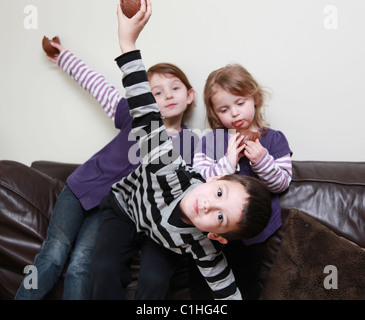 Children eating chocolate Easter Eggs, UK Stock Photo