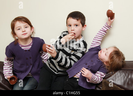 Children eating chocolate Easter Eggs, UK Stock Photo